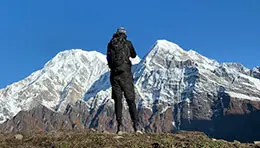 Traveler exploring the majestic Himalayan mountains, surrounded by rugged peaks and breathtaking natural scenery.