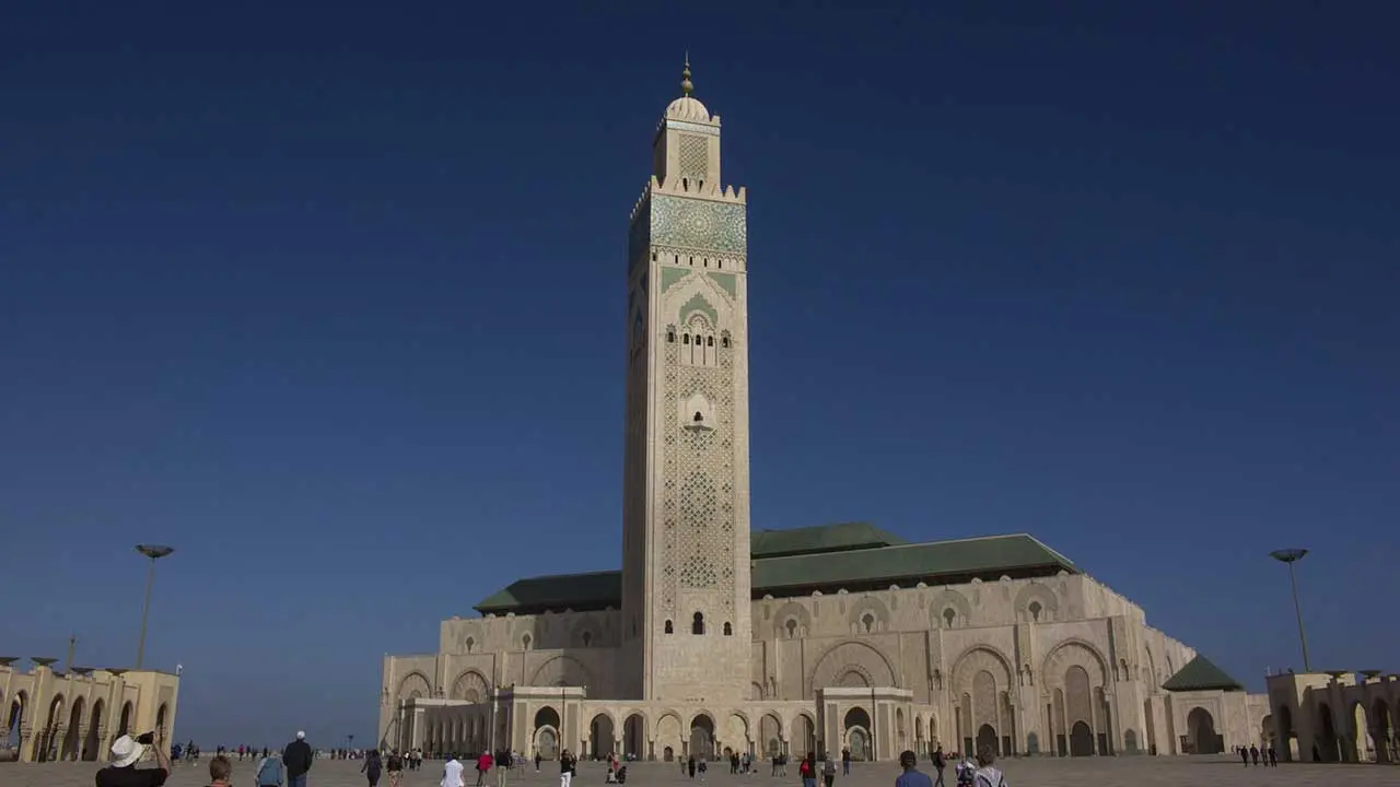 Vibrant market scene in the Medina of Marrakech, Morocco, with colorful textiles and traditional architecture