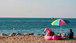 Peaceful sea beach with gentle waves, sandy shore, and a serene coastal atmosphere.